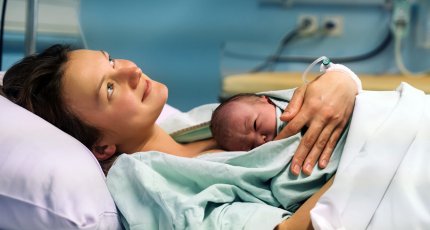 Mujer tras el parto, con el bebé en su pecho.